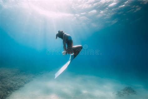 Lady Freediver In Bikini Posing Underwater In Blue Ocean Stock Image