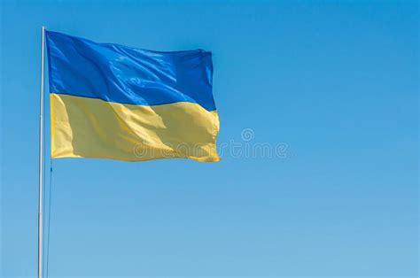 Get your ukraine flag in a jpg, png, gif or psd file. Yellow-blue Flag Of Ukraine In The Wind Against The Blue ...