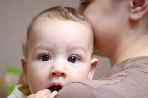 Pretty Young Mother Holding Her Newborn Baby Boy Close Up Stock Photo
