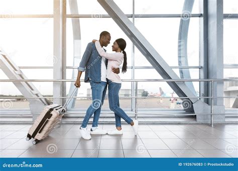 Ready For Honeymoon Travel Romantic African Couple Hugging At Airport Terminal Stock Image