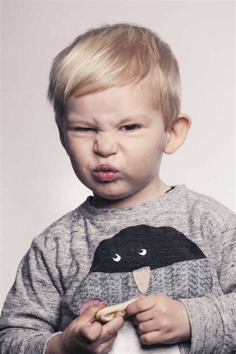 Portrait Of Little Boy Pouting A Mouth Stock Photo