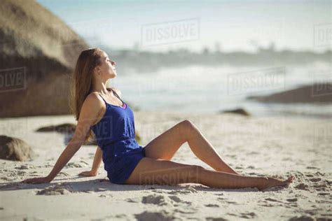 Beautiful Woman Relaxing On Beach On A Sunny Day Stock Photo Dissolve