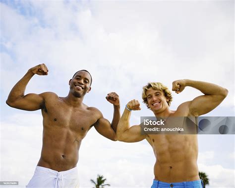 Happy Young Friends Flexing Muscles Stock Photo Download Image Now
