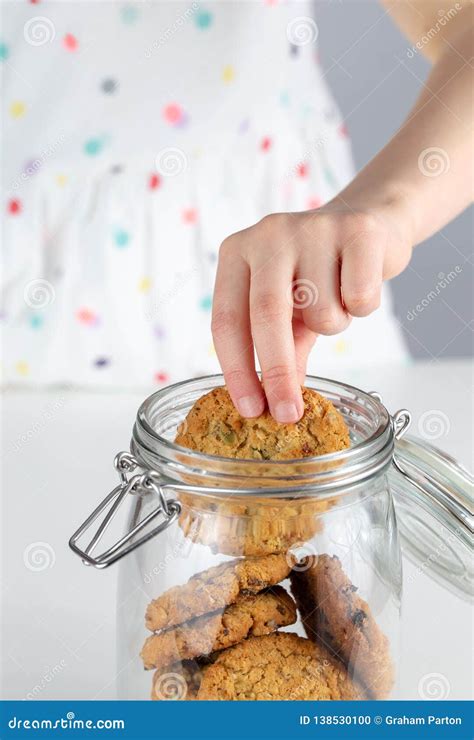 Hand In The Cookie Jar Taking A Cookie Stock Photo Image Of Delicious