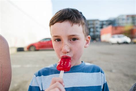 Boy Sucking On Popsicle By Stocksy Contributor Rob And Julia Campbell Stocksy