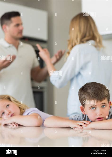 Sad Children Leaning On Table While Parents Arguing Stock Photo Alamy