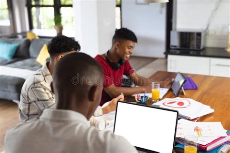 Happy Diverse Teenage Boys Using Laptop With Copy Space And Other