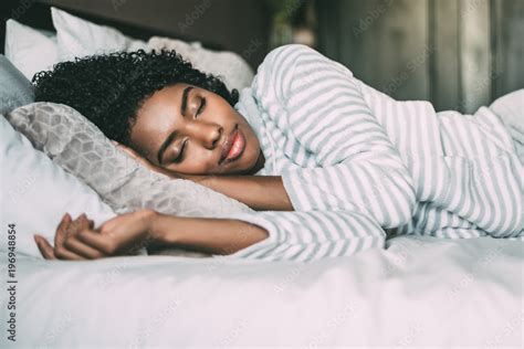 Close Up Of A Pretty Black Woman With Curly Hair Sleeping In Bed Closed