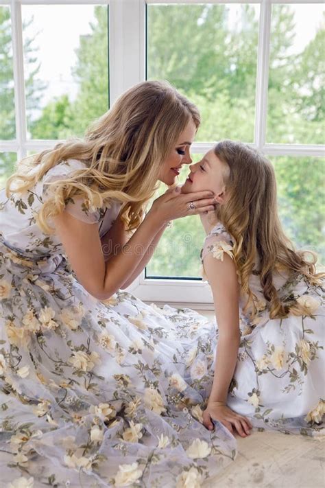 Mother Kissing Daughter In Matching Dresses Stock Image Image Of