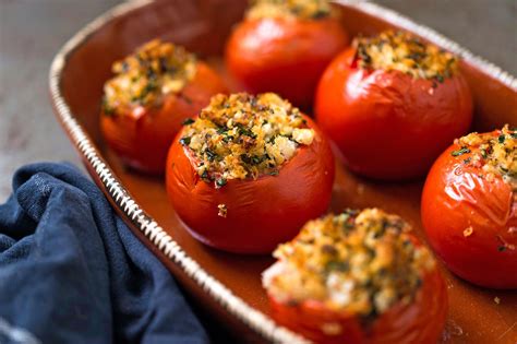 Several Stuffed Tomatoes In A Dish With Seasoning On Top Ready To Be Eaten