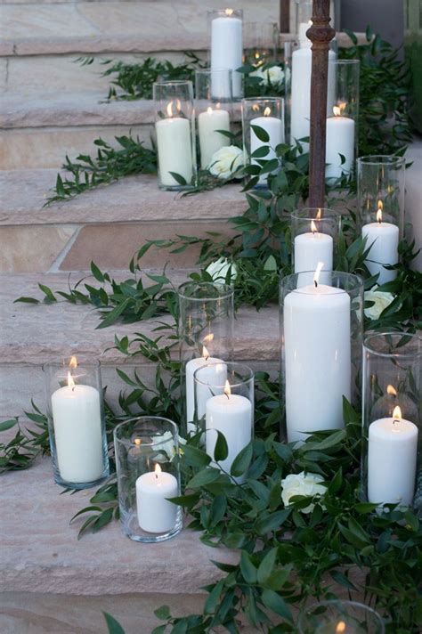 Pillar Candles And Greenery On Stairs Pillarcandles Pillar Candles Wedding Wedding Pillars