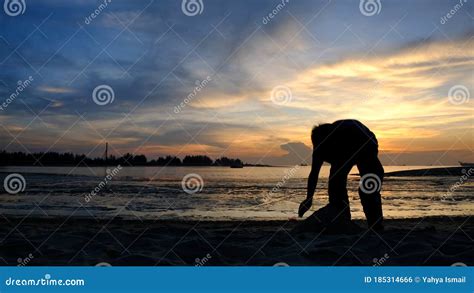 Silhouette Of Children Playing At Beach During Sunset Editorial Photo