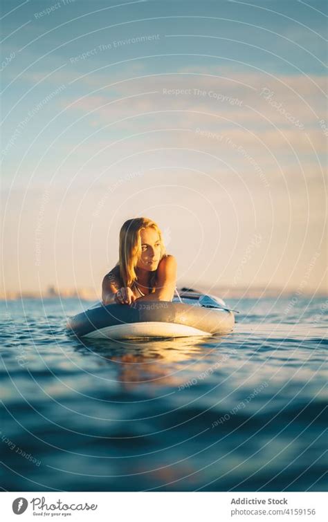 gelassene frau auf surfbrett im meer ein lizenzfreies stock foto von photocase