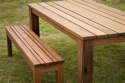 Mahogany benches provide easy seating for entertaining and serve as railings around two of the deck's edges. Custom outdoor dining table settings