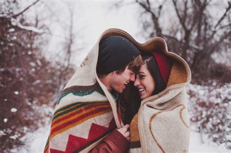 Two Lovers Snuggling Under A Blanket Winter Engagement Photos Cute Couples Couple Photography