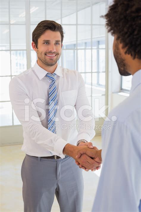 Smiling Businessmen Shaking Hands In Office Stock Photo Royalty Free
