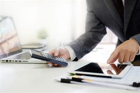 Close Up Businessman Calculate Finance Data In Tablet Computer A Stock