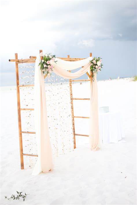 You can order a wooden or a forged arch and then decorate it according to your taste: Rustic Romantic Bamboo Wedding Arch with Seashells