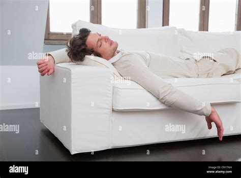 Man Sleeping On Sofa In Living Room Stock Photo Alamy