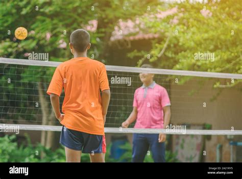 Students Playing Traditional Asian Sport Game Sepak Takraw In School