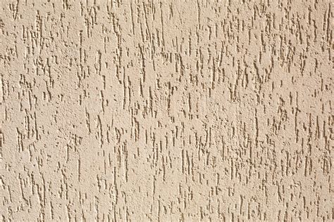 Plaster On The Wall With A Bark Beetle Pattern Of Beige And Sand Color