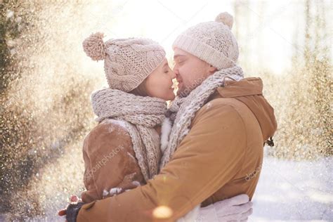 Loving Couple Kissing In Snowfall Stock Photo By ©pressmaster 62859267