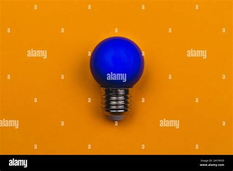 Blue Light Bulb On A Yellow Background Single Bulb With Copy Space