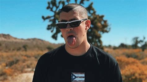 Bad Bunny Aesthetic Is Wearing Black Tshirt Standing In Blur Background