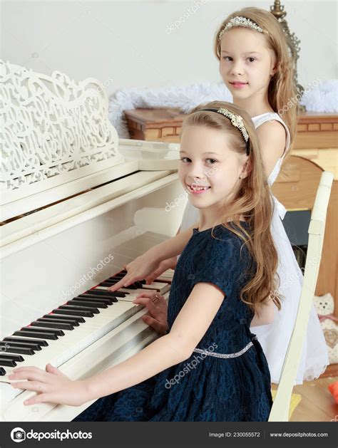 Girls Twins Playing The Piano Stock Photo By ©lotosfoto1 230055572