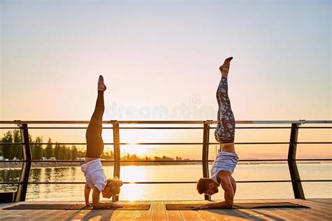 Couple Doing Practicing Yoga Together On Nature Outdoors Morning