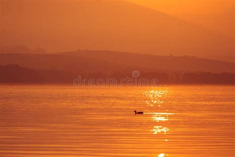 A Beautiful Sunrise Over The Lake With Mountains In Distance Morning