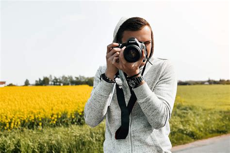 Young Photographer in Action Taking a Photo Free Stock Photo | picjumbo