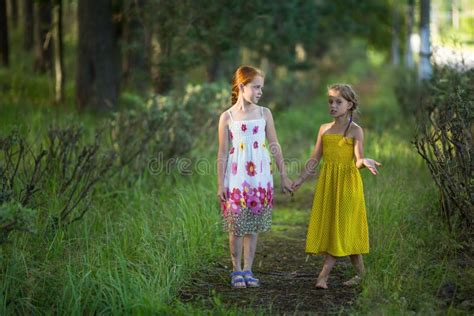 Two Kids Girls Talking In The Park Holding Hands Nature Stock Image