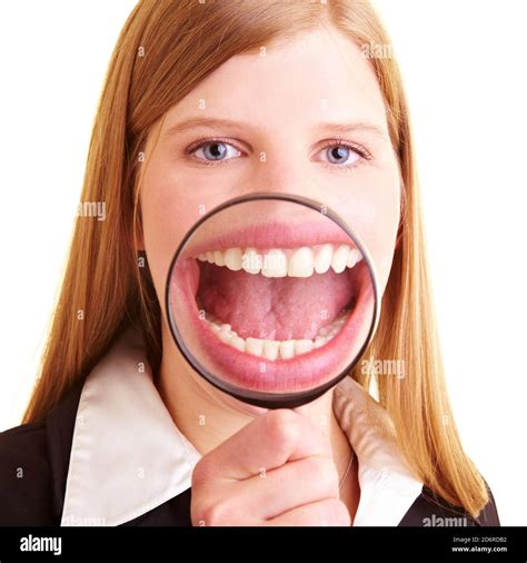 Laughing Businesswoman Holds A Magnifying Glass In Front Of Her Mouth