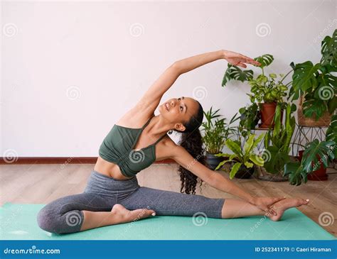 A Young Multi Ethnic Woman Reaches Overhead In Seated Side Stretch Yoga