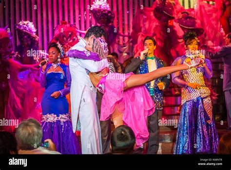 Exotic Dancers Performing Live On Stage In Colourful Costumes In A Cabaret Show For Tourists In