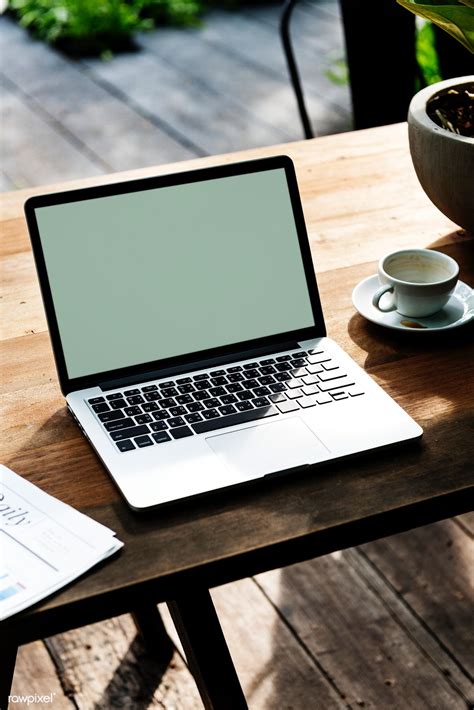 Download Premium Psd Of Laptop With An Empty Screen On A Wooden Table