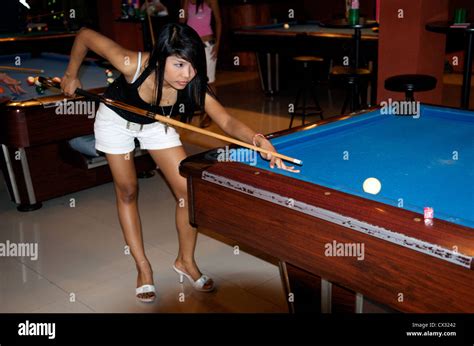 a scantily clad very sexy bar girl shooting pool at a girly bar sukhumvit road bangkok