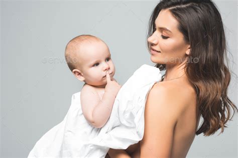 Portrait Of Attractive Smiling Naked Mother Hugging Baby Boy Isolated
