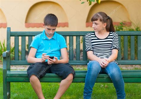 Teenage Girl Looking With Love At Indifferent Teenage Boy Stock Photo