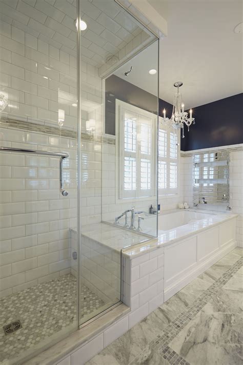 glass enclosed shower with bench connected to the platform of a soaking tub with heated to