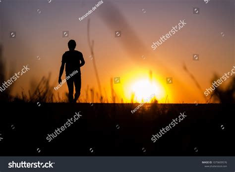 Silhouette Man Walking Sunset Stock Photo 1079609576 Shutterstock