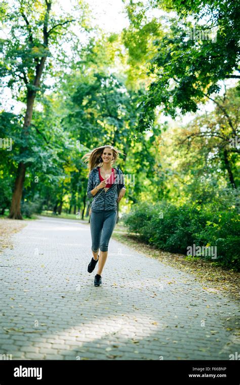 Young Blonde Woman Jogging In Park Stock Photo Alamy