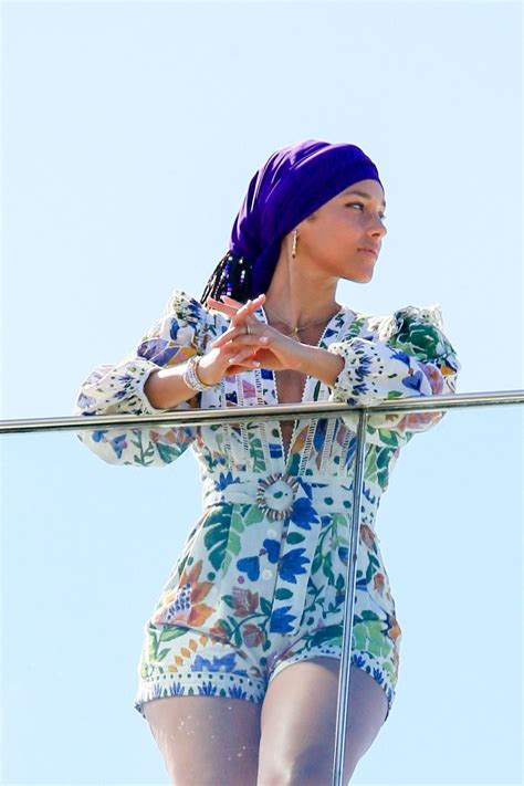 Alicia Keys Wearing A Colored Flower Print Romper And A Purple Headband