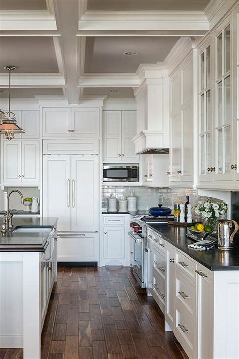 It uses cup pulls for its drawers to give the cabinets a more classic look, yet still match the brushed stainless steel finish of the kitchen. Gray Painted Coffer Ceiling - Cottage - Kitchen