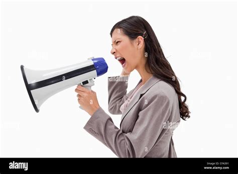 Side View Of Angry Businesswoman Yelling Through Megaphone Stock Photo