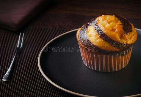 Vanilla Muffin With Chocolate Marbled In Brown Paper Close Up Stock