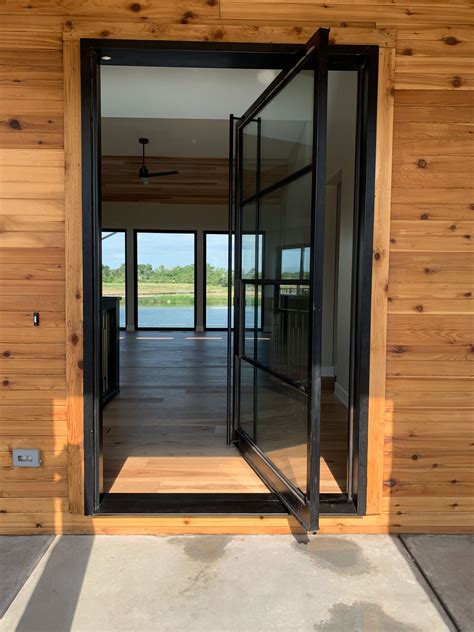 Iron Pivot Glass Doors Maximize The View And Increase Natural Light In