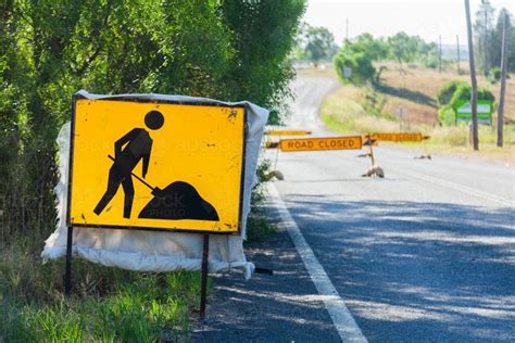 Image Of Roadwork Sign Of Person Digging Hole And Road Closed Signs