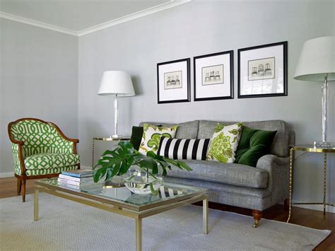 A Series Of Patterned Green Pillows Pop Against The Gray Sofa And Wall